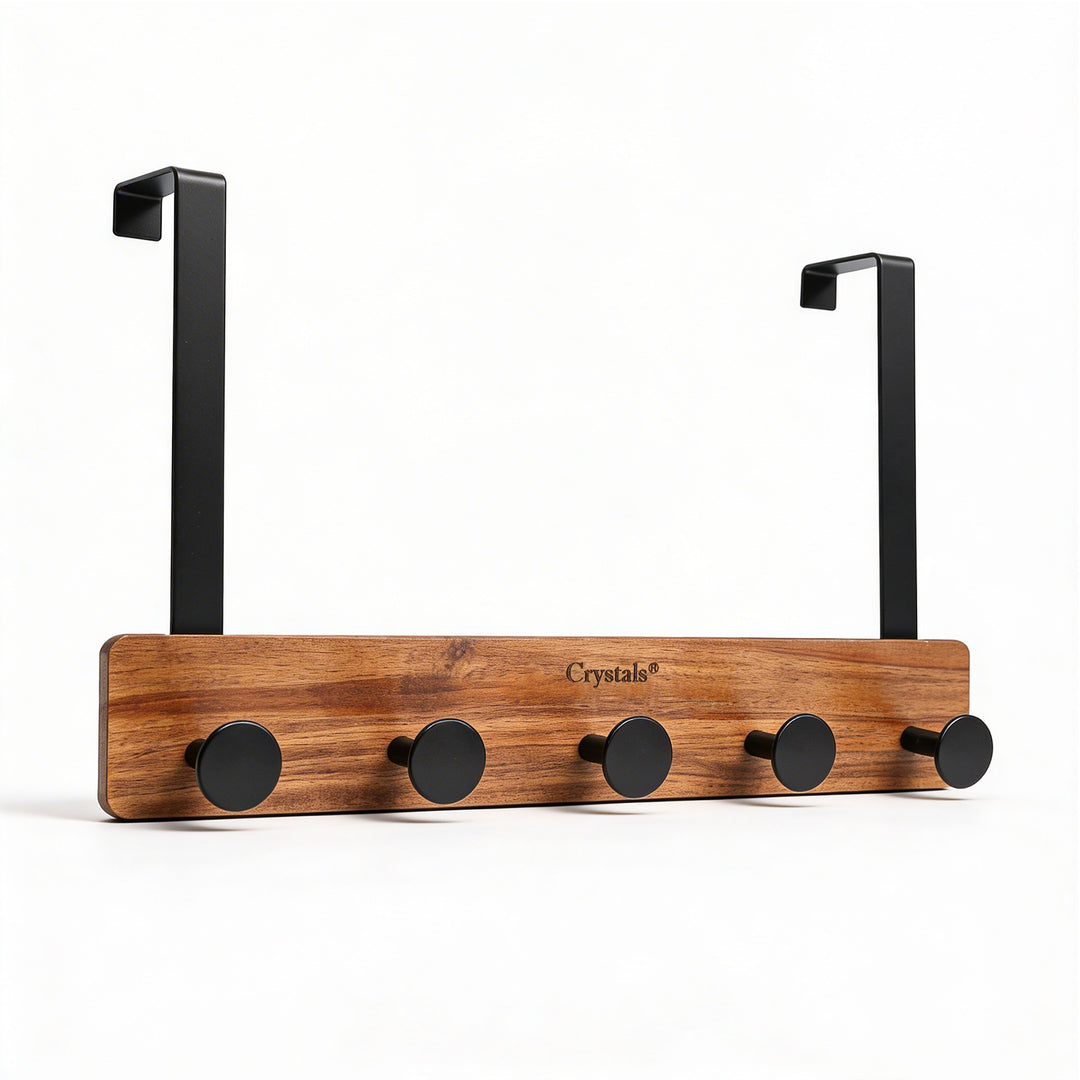Wooden coat rack with black hooks on a white background