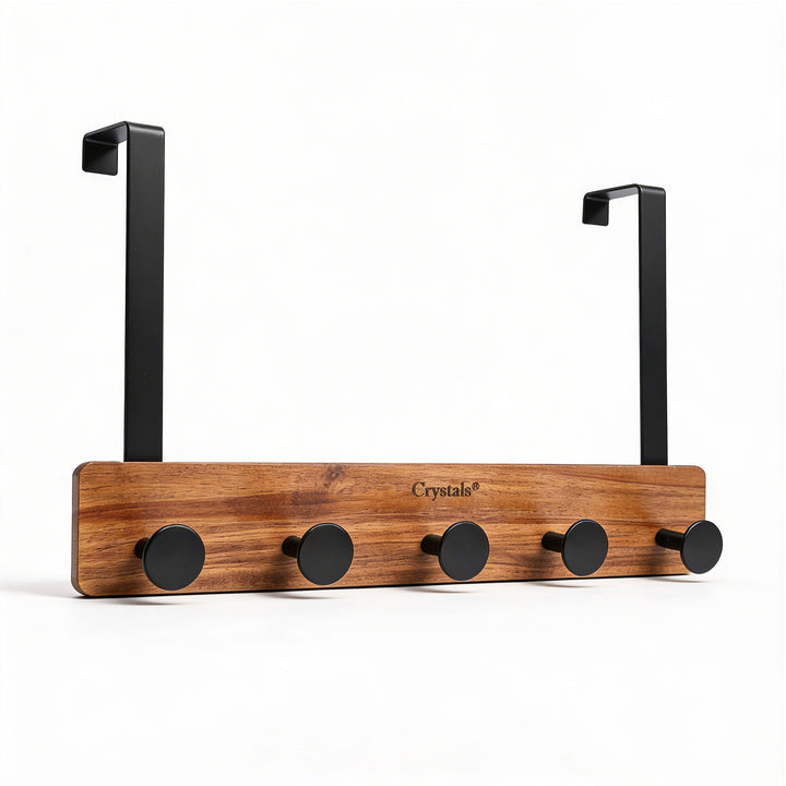 Wooden coat rack with black hooks on a white background